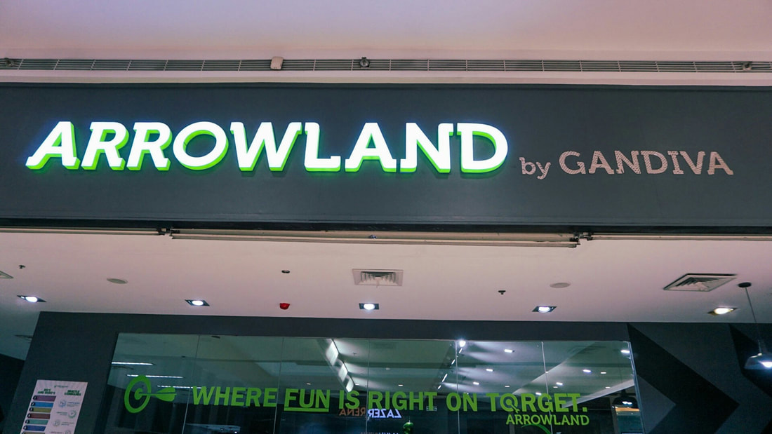 Arrowland by Gandiva signage lit up at SM Megamall entrance